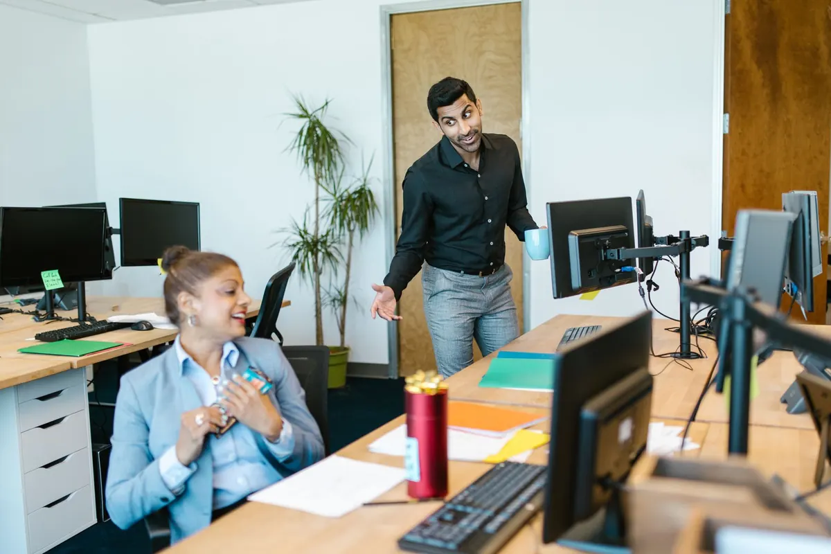 A recruiter talking a candidate through a role at her desk