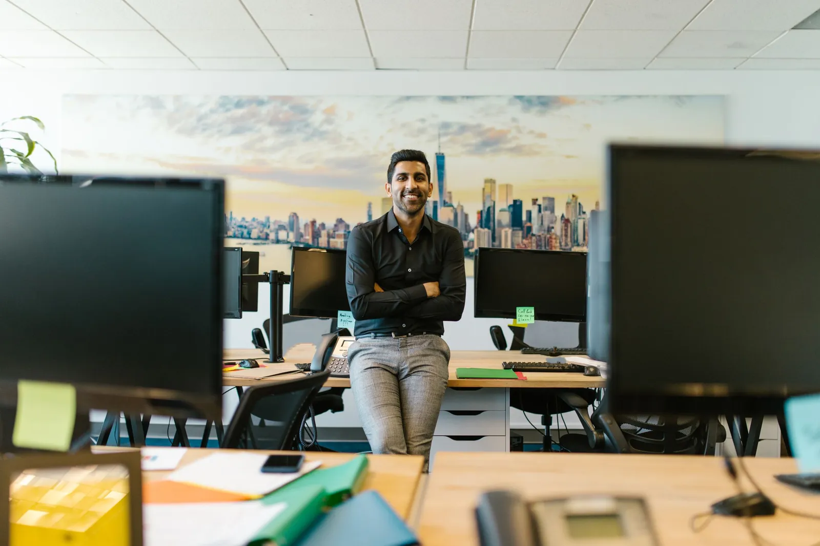 A KYC Solutions advisor at his desk, smiling across the table